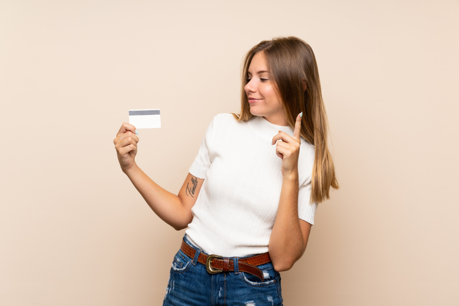 Woman holding a Mission Lane credit card.