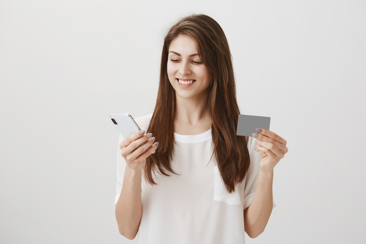 Woman holding her QuicksilverOne Capital One.