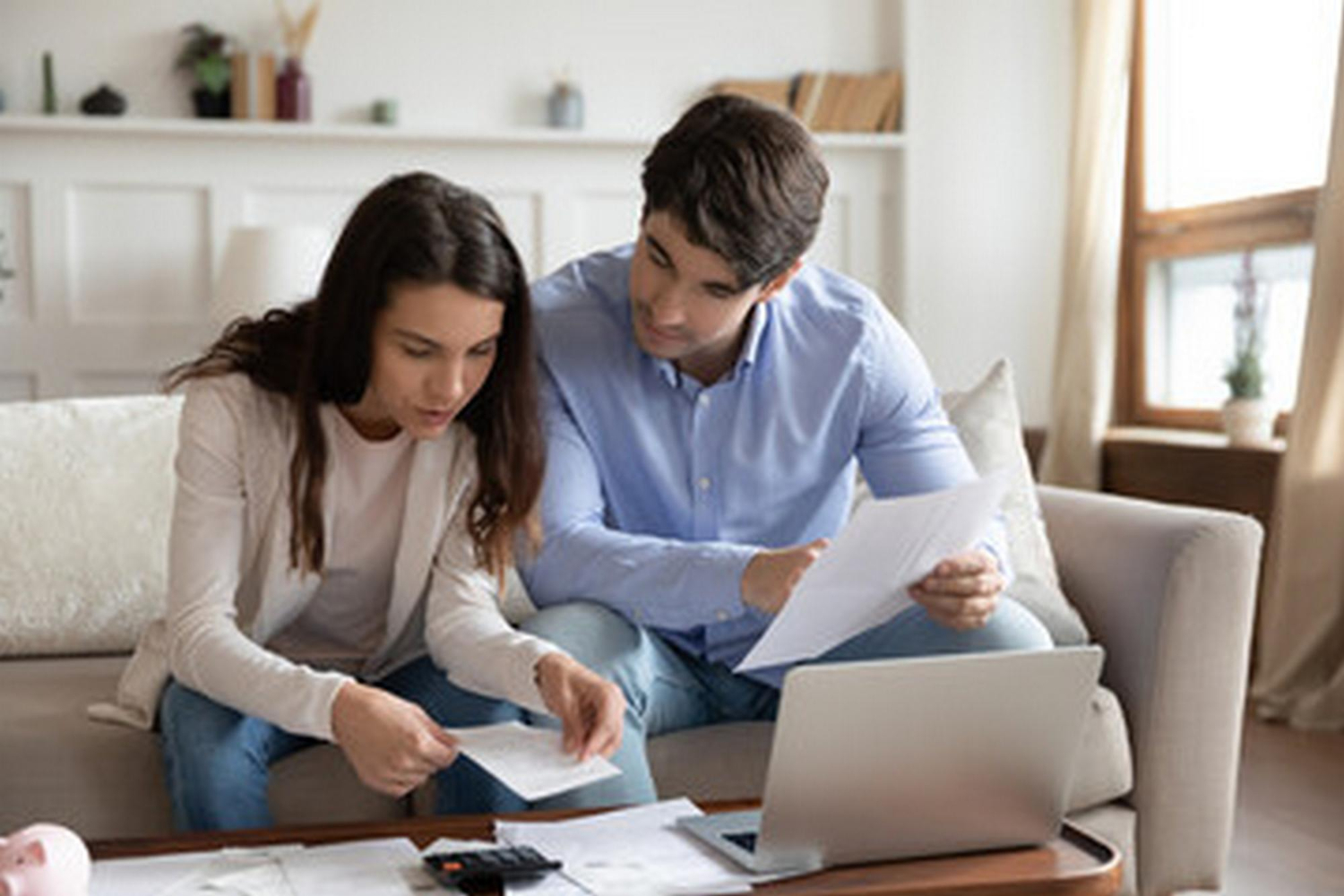 A couple checking a Mortgage Refinancing.