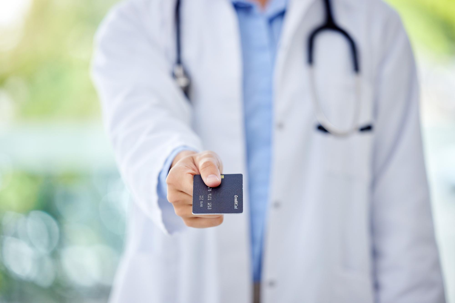 A person holding a Medical Credit Cards.