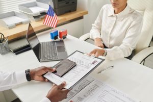 A person signing papers after Obamacare Paperwork Changes.